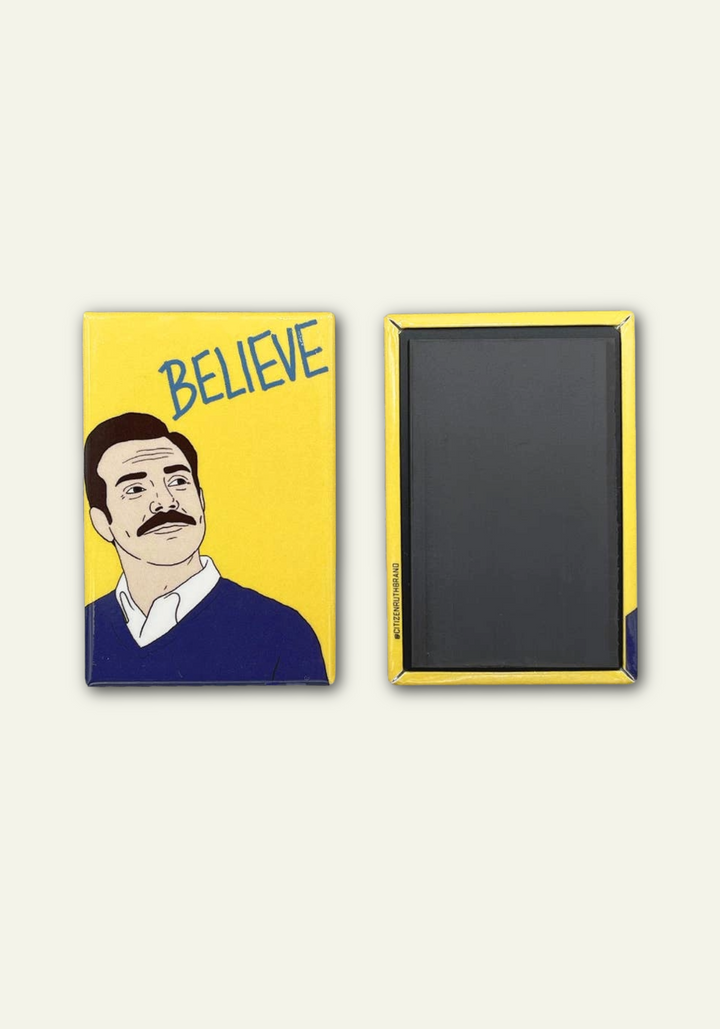 A yellow magnet with a graphic of Ted Lasso and the word &